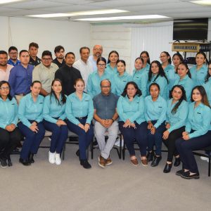 Office team group photo in workplace setting.