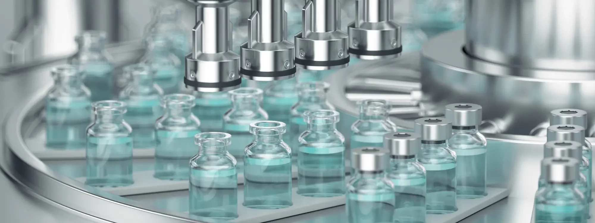 Vials of vaccines being filled by machinery in a biopharmaceutical manufacturing setting