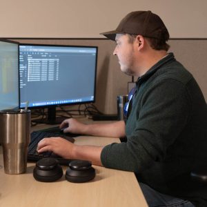 Person working at computer with multiple screens